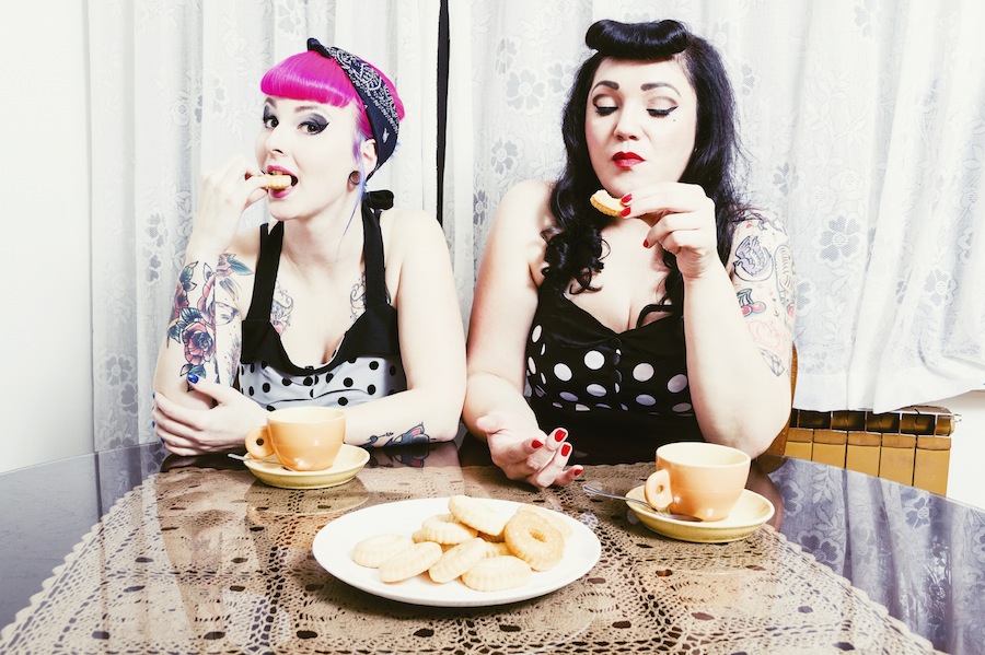 Two ladies eating cupcakes