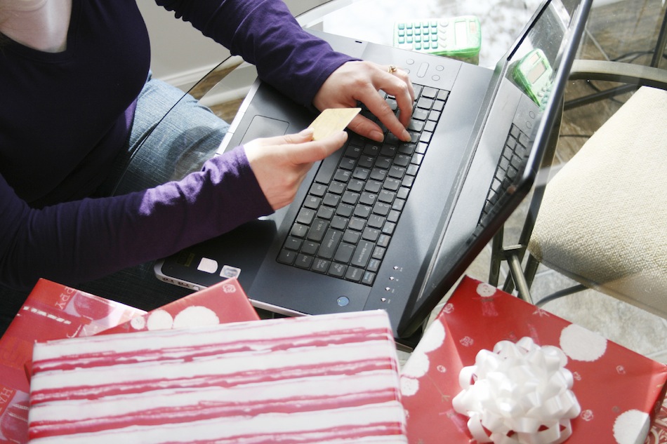 Woman on computer with presents