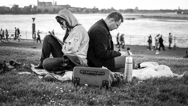 Two people on tablets in the park