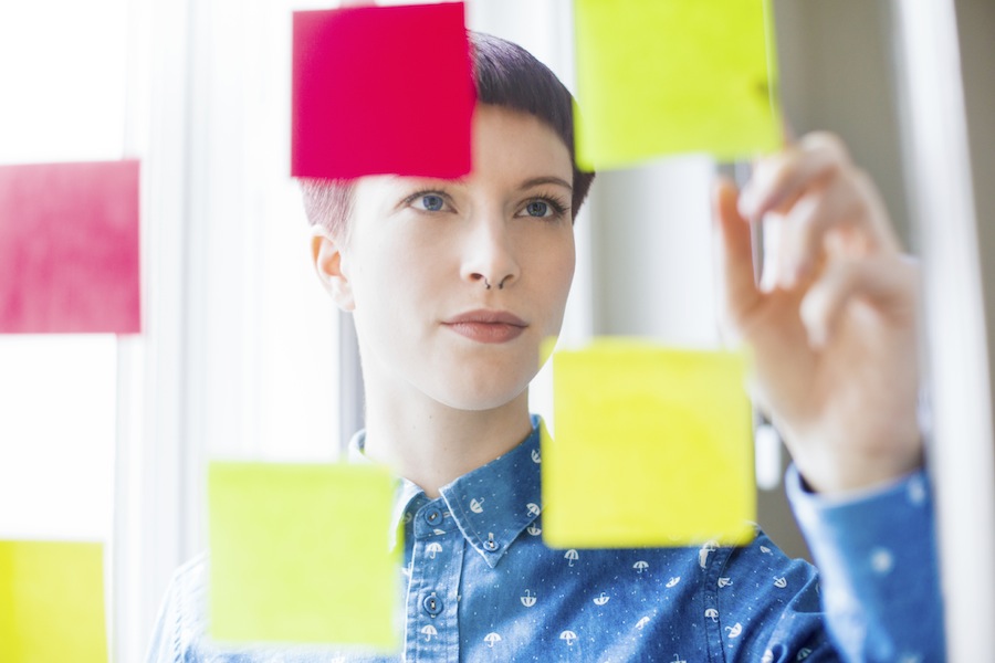 Woman organizing design criteria with post-it notes